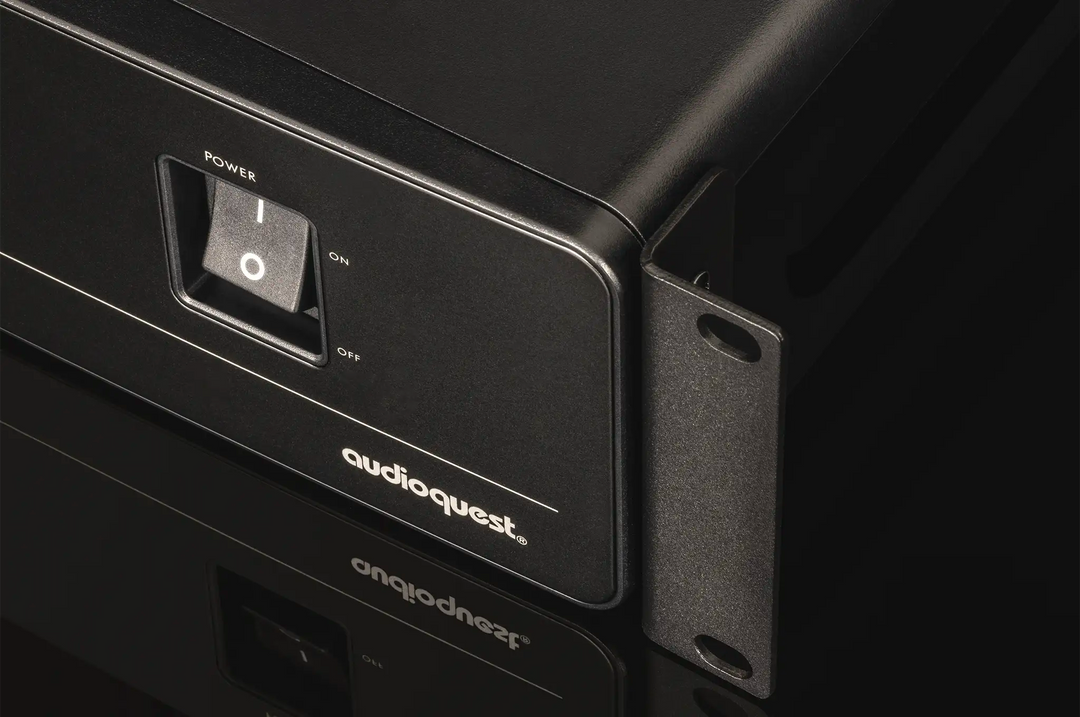 AudioQuest PowerQuest 303 Power Conditioner sitting front left 3 quarter angle power switch closeup on black background