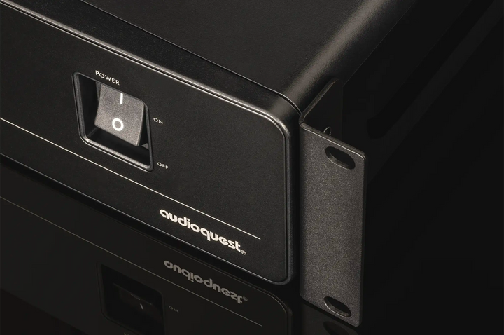 AudioQuest PowerQuest 303 Power Conditioner sitting front left 3 quarter angle power switch closeup on black background