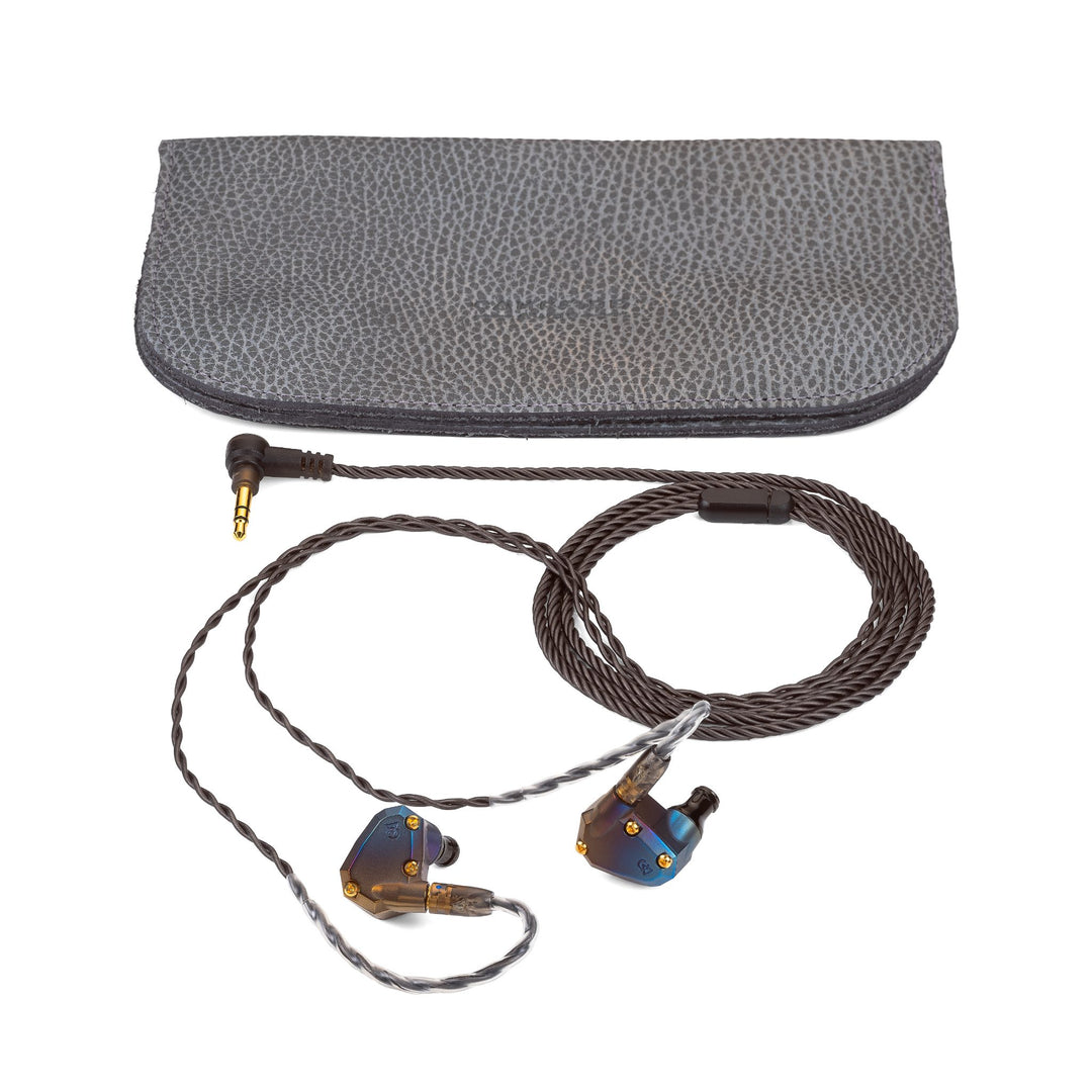 Campfire Audio Moon Rover quarter with attached coiled stock cable and leather bifold over white background