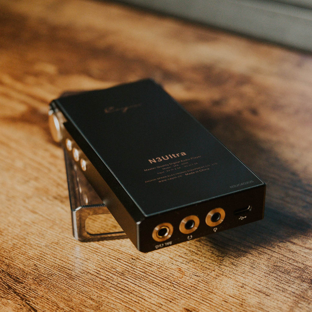Cayin N3Ultra closeup on stock case over wood cabinet