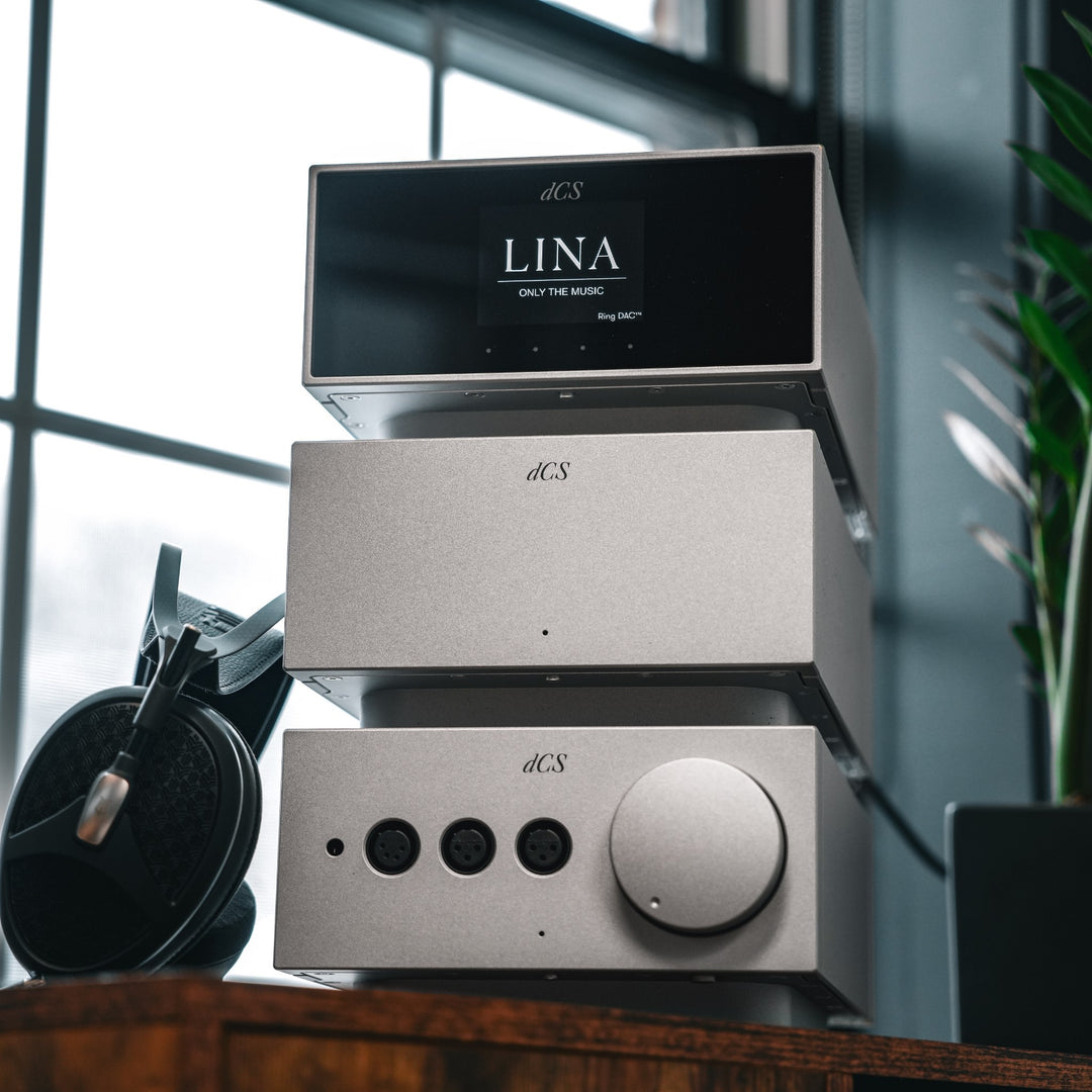 dCS Lina full system silver cool dramatic front quarter with Meze headphones