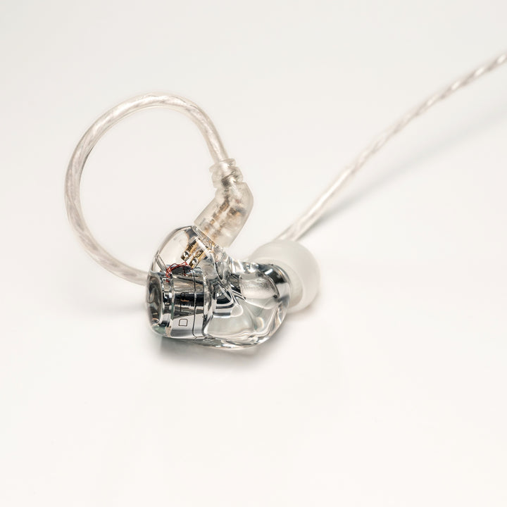 DITA Audio Project M right earphone closeup with attached stock cable over white background