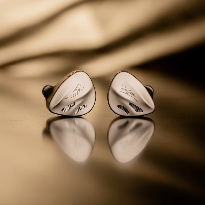 DUNU Vulkan 2 IEMs front center view on bronze reflective background