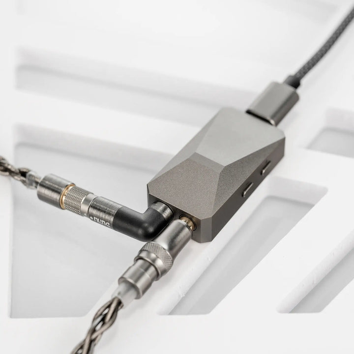 DUNU DTC 480 DAC and amp laying on white background with cables plugged in