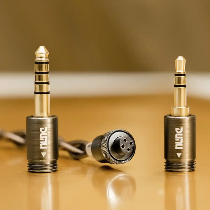 DUNU Q-Lock Mini interchangeable plug system closeup of terminations on gold and beige background