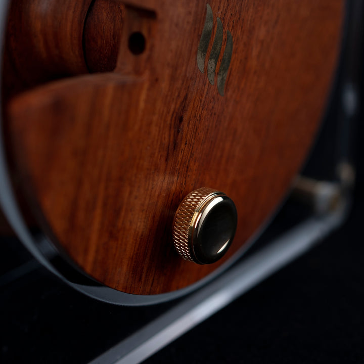 Effect Audio Centurion display stand closeup brass knob and rosewood over black background