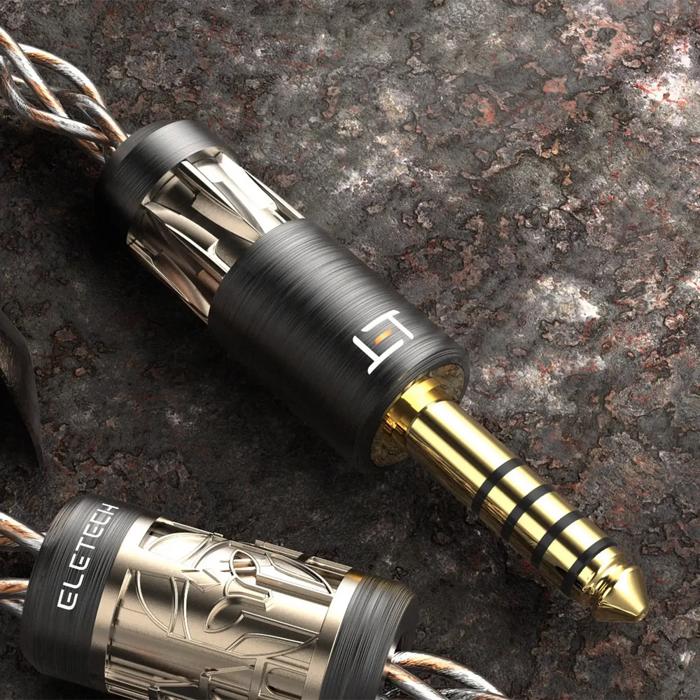 Eletech Odyssey IEM cable termination closeup on dark stone background