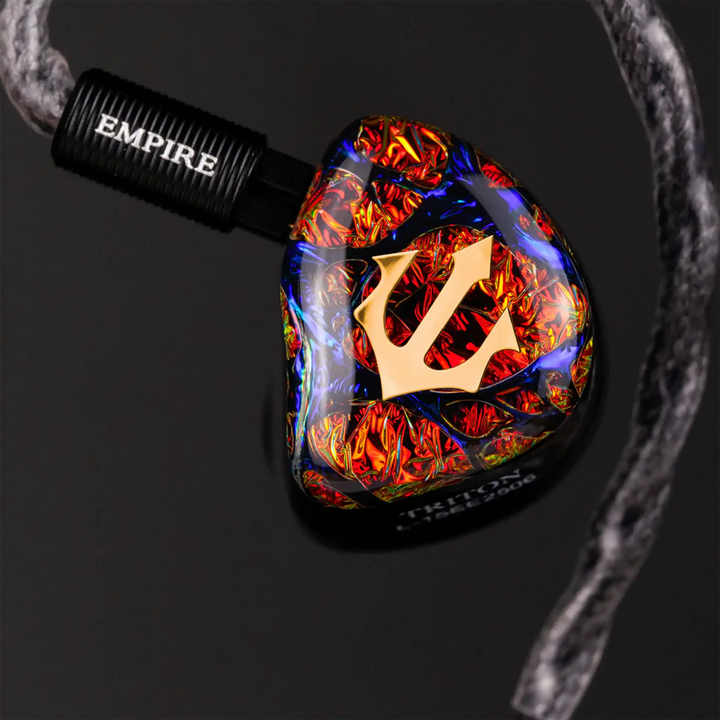 Empire Ears Triton IEM front view floating attached to cable dark background
