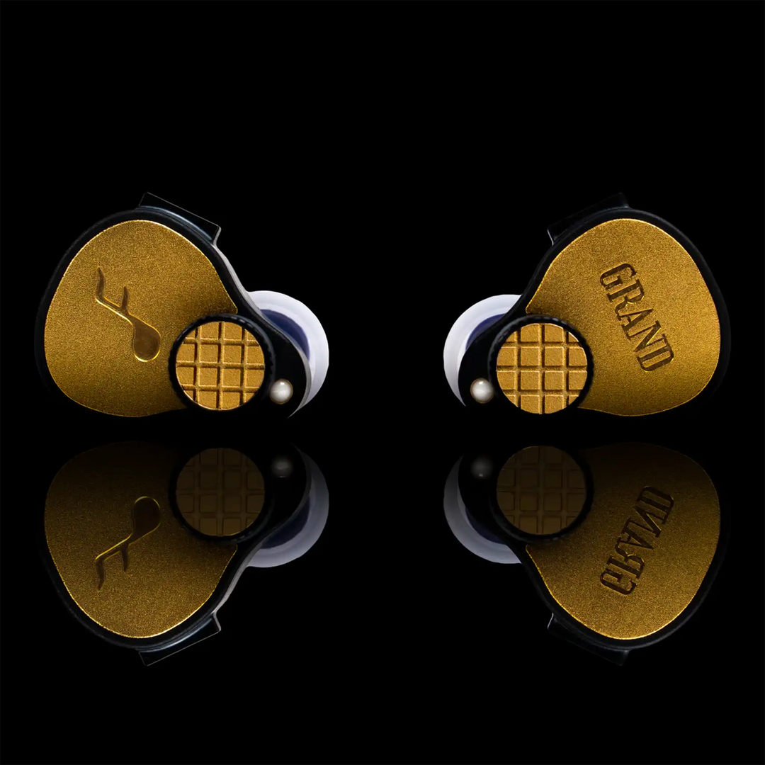 FATfreq Grand Maestro Limited Edition IEMs sitting front center on black reflective background