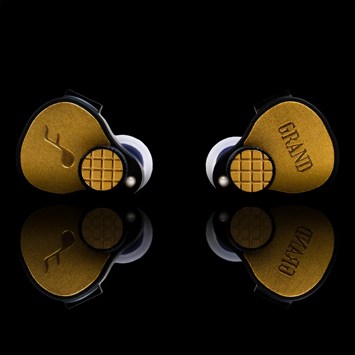 FATfreq Grand Maestro Limited Edition IEMs sitting front center on black reflective background