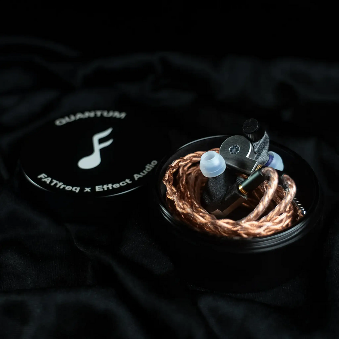 FATfreq x Effect Audio Quantum iems wrapped with cable sitting on metal case next to lid with logo on black satin background