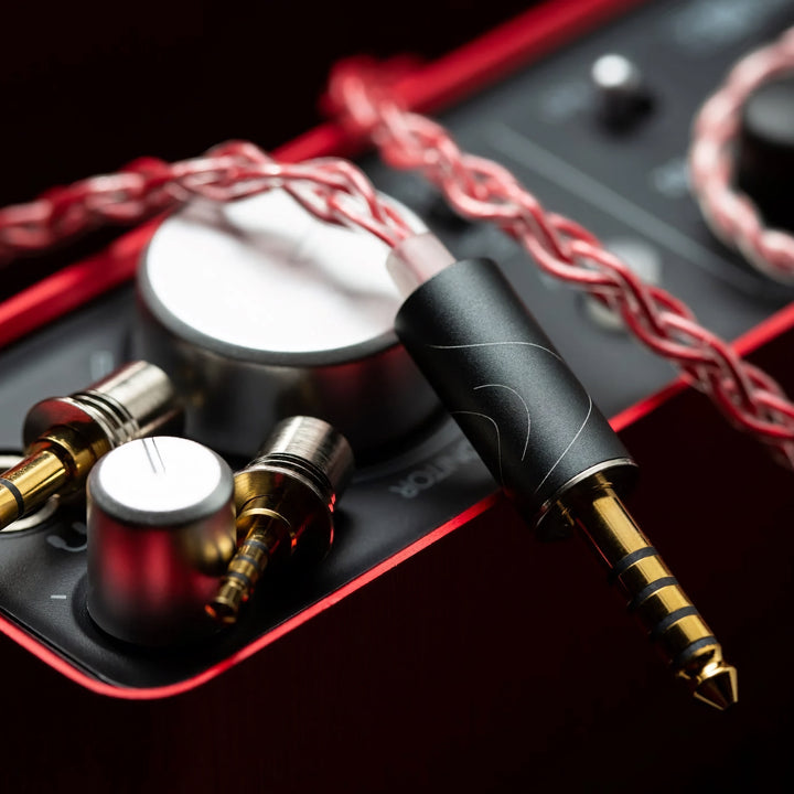 FATfreq Scarlet Mini upgraded red cable highlighting 4.4mm connector with modular tips over red amplifier