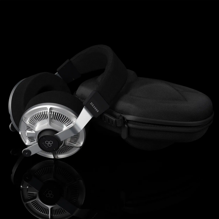 Final Audio DX6000 headphones leaning right on hard carrying case on black background