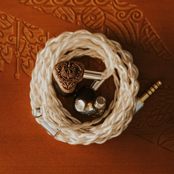 FlipEars Aegis earphones closeup inside attached coiled stock cable over textured wood background