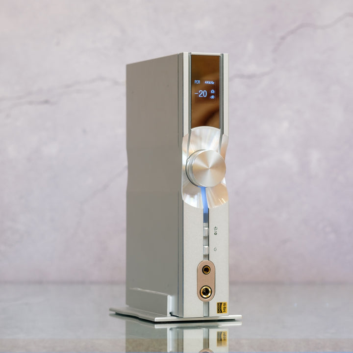 iFi NEO iDSD 3 quarter vertical mount on stand over marble background