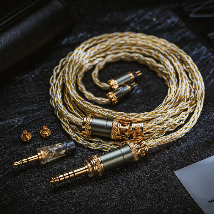 Kinera MIA coiled cable with attached 2-pin tips and all accessories over back leather