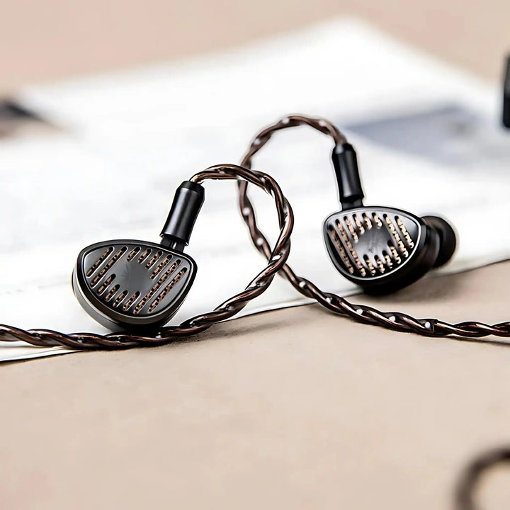 Kiwi Ears Septet IEMs sitting face forward with cable attached on top of infographic