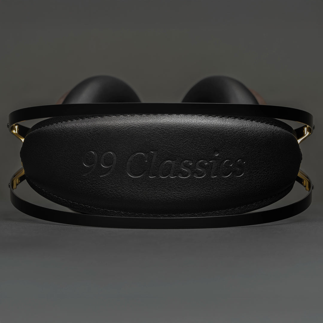 Meze 99 Classics 2nd Gen headphones lying down eye level view of headband with 99 classics logo on grey background