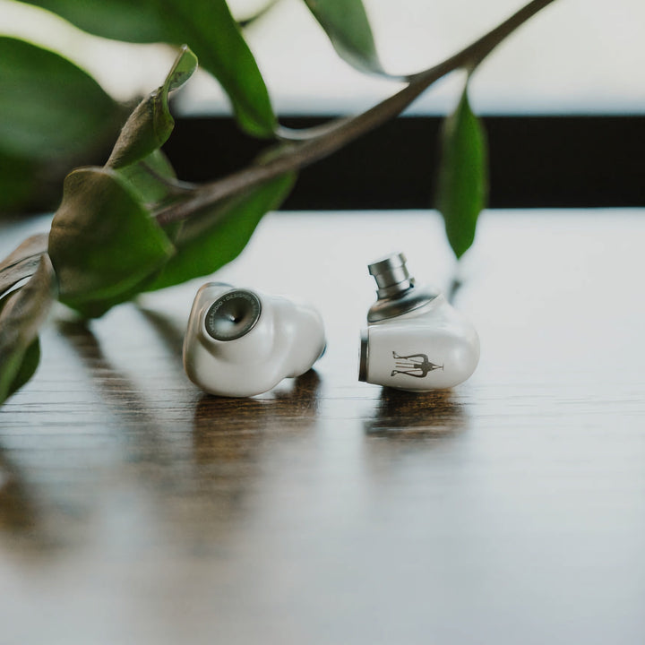 Meze Audio Alba on wood table with plant
