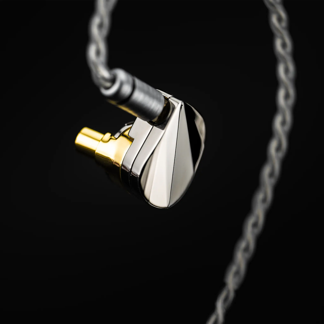 Moondrop Illustrious IEM floating left side view with cable attached on black background