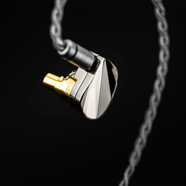 Moondrop Illustrious IEM floating left side view with cable attached on black background