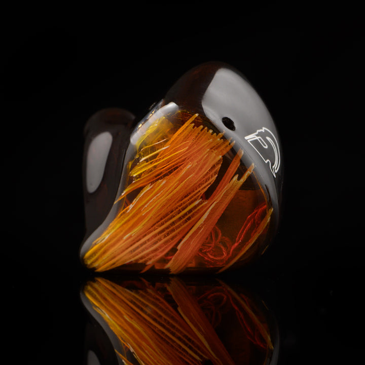 Noble Audio Spartacus single IEM front closeup over black reflective background