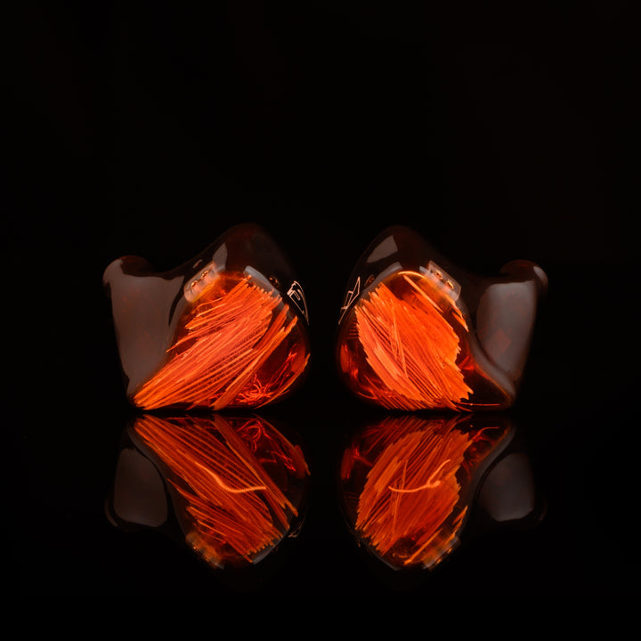 Noble Audio Spartacus IEM front dramatic intense orange highlight over black reflective background
