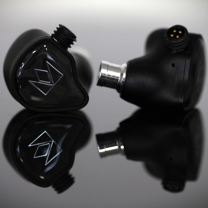 Noble Audio XM-1 front and profile closeup over gray reflective background