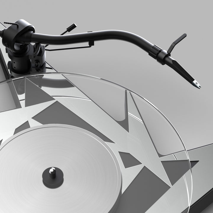 Pro-Ject Metallica turntable closeup tonearm and glass platter over gray background