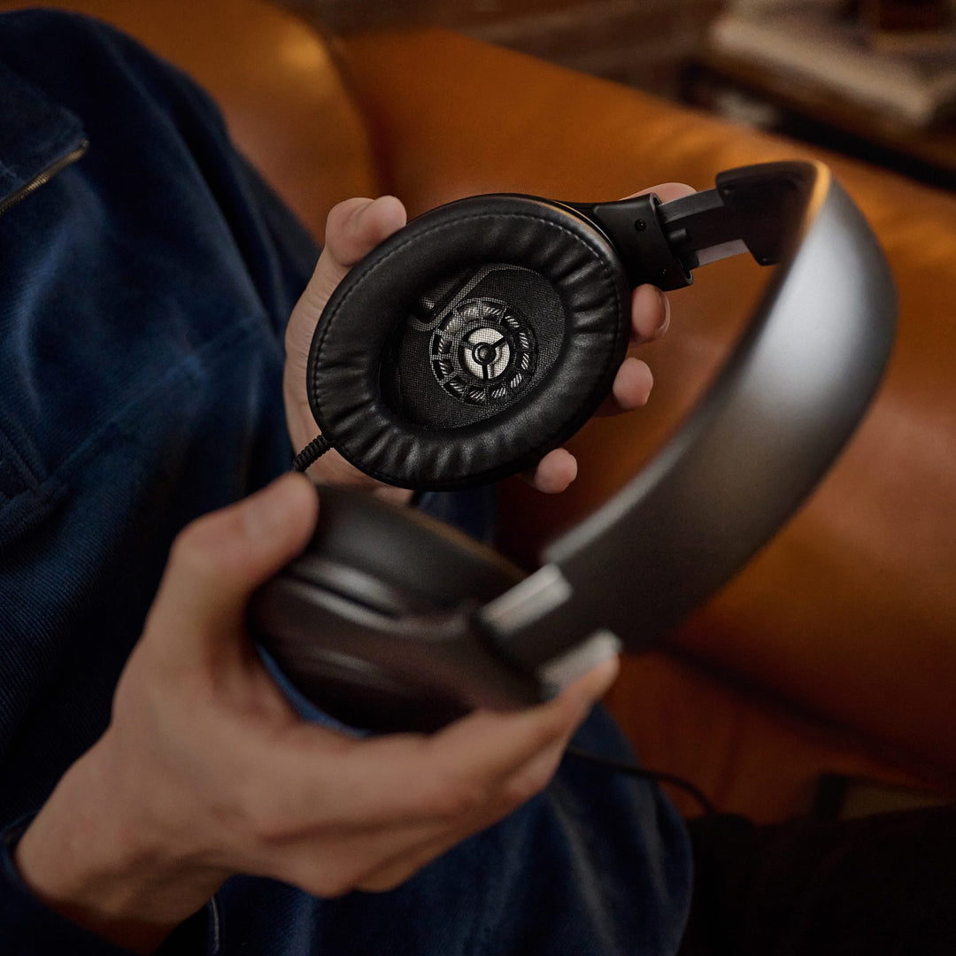 Human holding Sennheiser HD 620S highlighting inner ear cup showing transducer