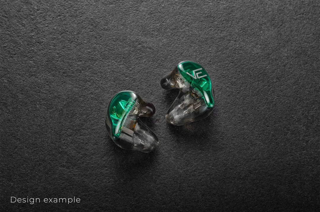 Vision Ears VE ONE IEMs sitting slightly diagonally green faceplate facing out on dark grey background