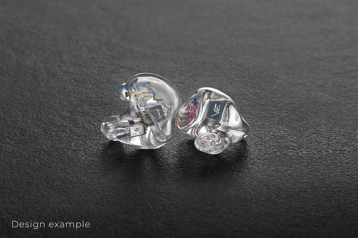 Vision Ears VE ONE IEMs sitting front and side view clear faceplate facing out on dark grey background