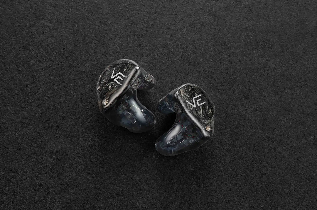 Vision Ears VE PRO IEMs sitting diagonally faceplate facing out on dark grey background