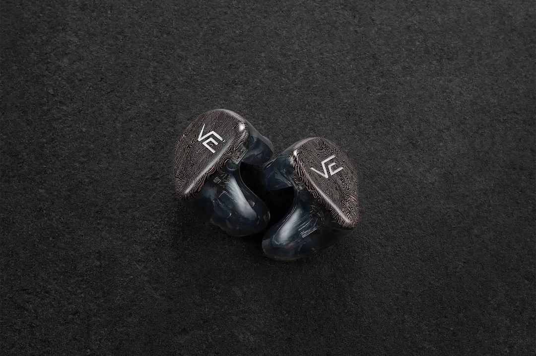 Vision Ears VE PURE IEMs sitting next to each other faceplate facing out on dark grey background