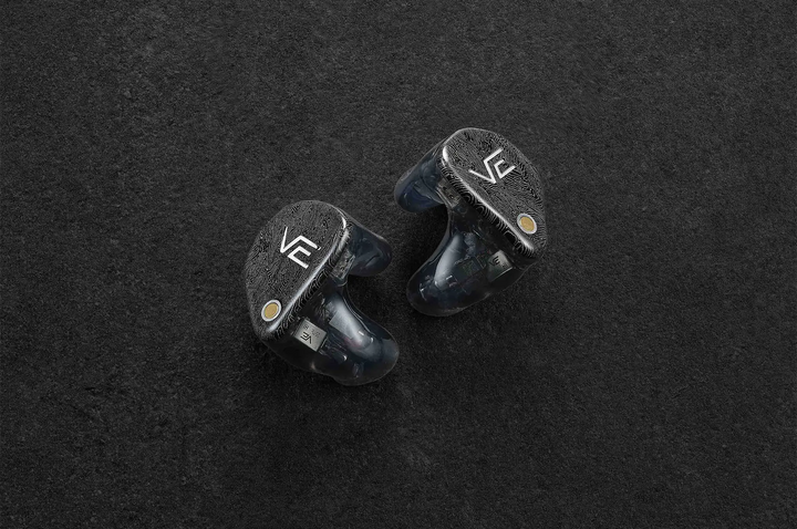 vision ears VE XCON IEMs sitting beside each other faceplate facing out on dark grey background