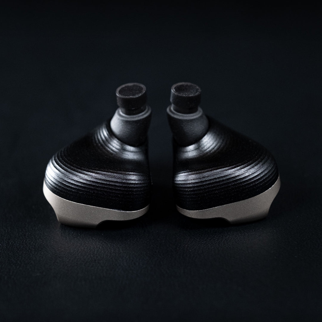 Vision Ears VE10 rear highlighting bores over dark leather background