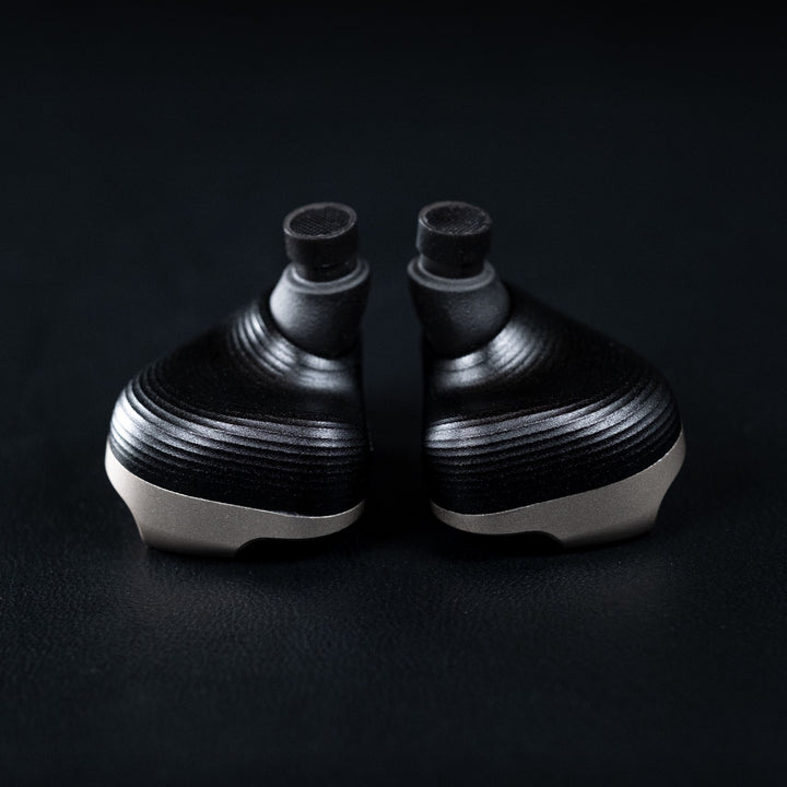 Vision Ears VE10 rear highlighting bores over dark leather background