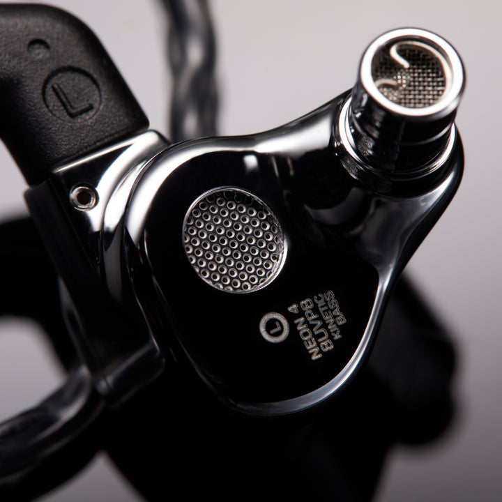 FiR Audio Neon 4 rear closeup with attached cable over black reflective background