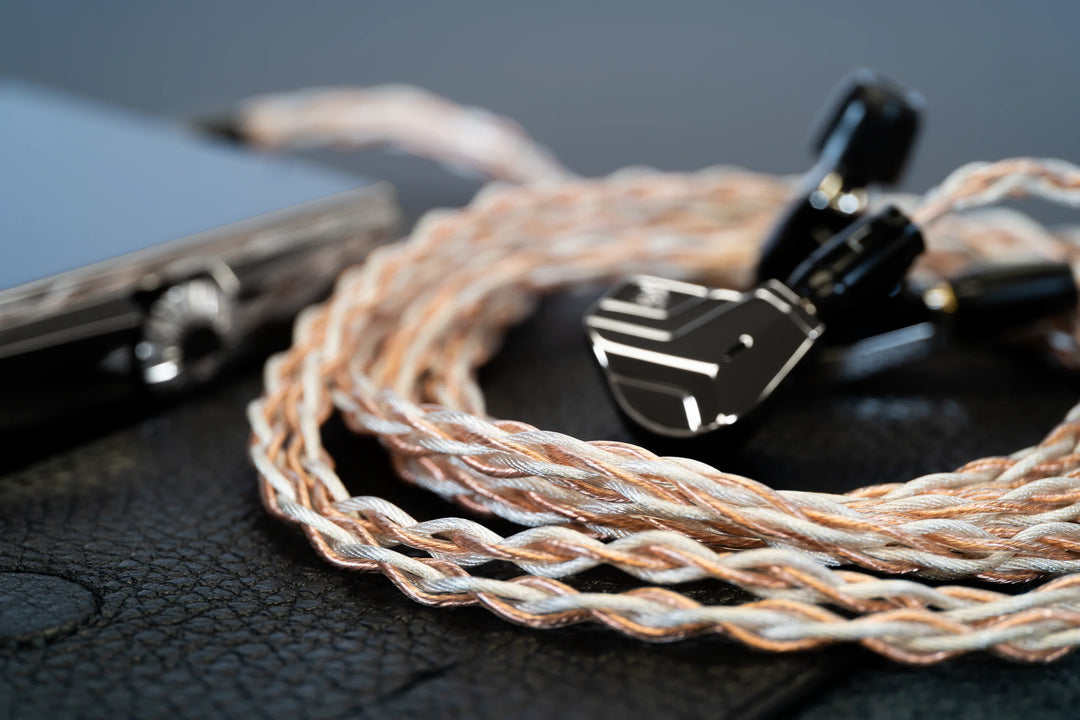 Campfire Audio Time Stream: Ultra cable with Astrolith IEM and dap on black leather surface