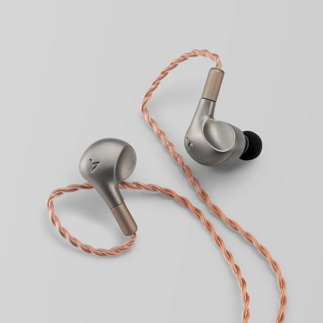 Astell&Kern LUNA IEMs sitting diagonally on grey backdrop with Eletech cable attached 