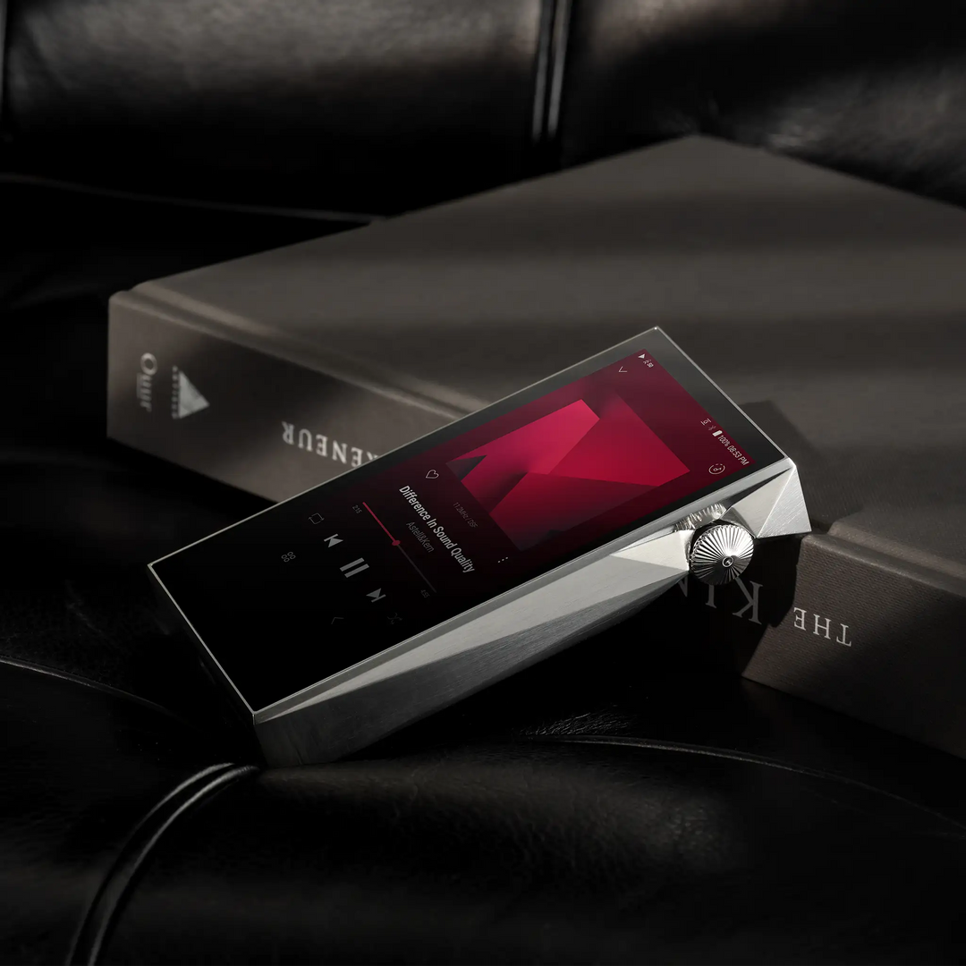 Astell&Kern SP3000M Copper Nickel leaning on book on black leather couch