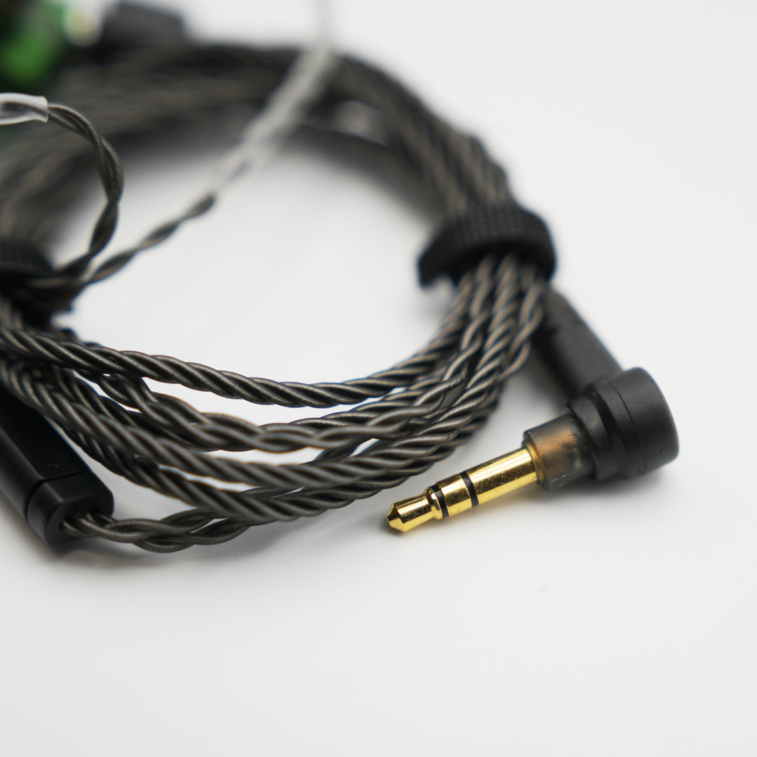 Campfire Audio Andromeda 2019 coiled stock cable highlighting 3.5mm jack over white background from Bloom Audio gallery
