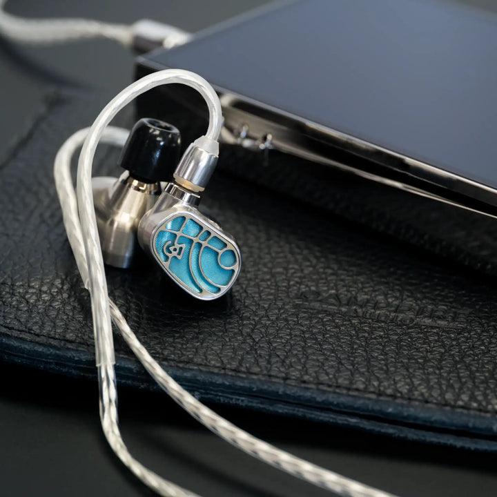 Campfire Solaris Siren MV3 pair over black leather bifold with attached Time Stream cable