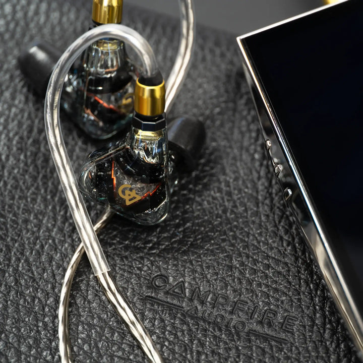 Campfire Audio Trifecta Cosmic Gateway over black leather pouch with audio player