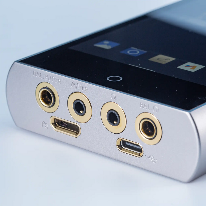 Cayin N7+ DAP lying face up closeup of bottom outputs at right 3 quarter angle whitebox