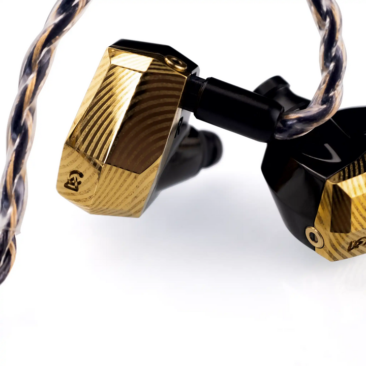 Campfire Audio Andromeda 10 SE gold IEMs plugged into cable closeup of CFA logo whitebox