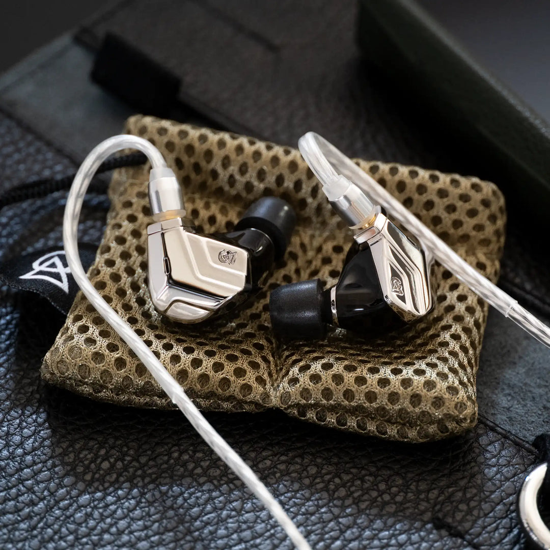 Campfire Audio Astrolith with attached stock cable on tan mesh bag