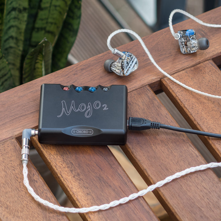Chord Mojo 2 lifestyle with attached USB cable and earphones