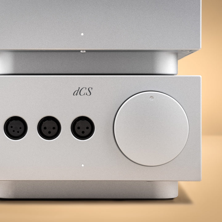 dCS Lina headphone amp silver front closeup over peach background