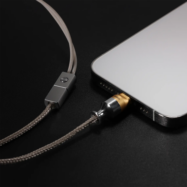 ddHiFi M110A cable plugged  into iPhone sitting on black table